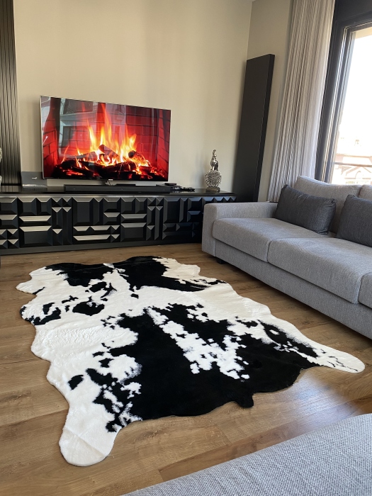 The artificial cow rug features a realistic, printed design that brings a touch of nature into you home decor