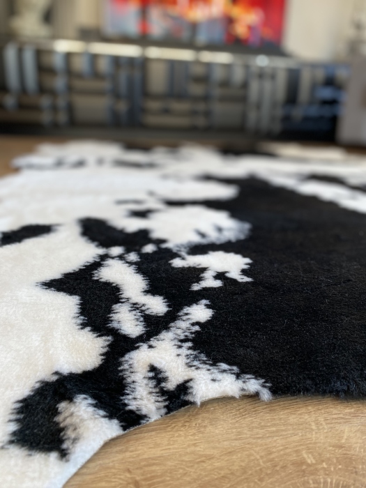 The artificial cow rug features a realistic, printed design that brings a touch of nature into you home decor