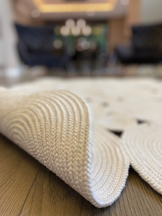 Experience the luxurious feel of a handmade natural jute rug with its high-quality fibers and unique designs.