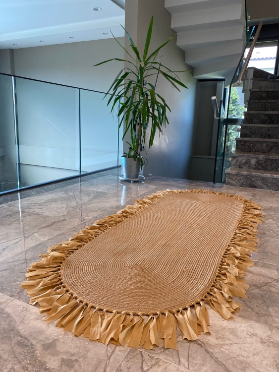 Experience the luxurious feel of a handmade natural jute rug with its high-quality fibers and unique designs.