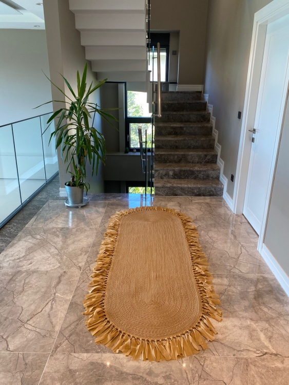 Experience the luxurious feel of a handmade natural jute rug with its high-quality fibers and unique designs.