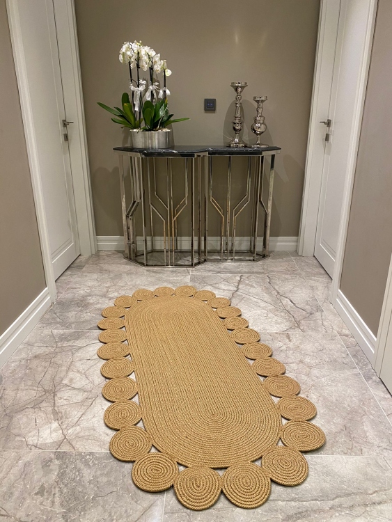 Experience the luxurious feel of a handmade natural jute rug with its high-quality fibers and unique designs.