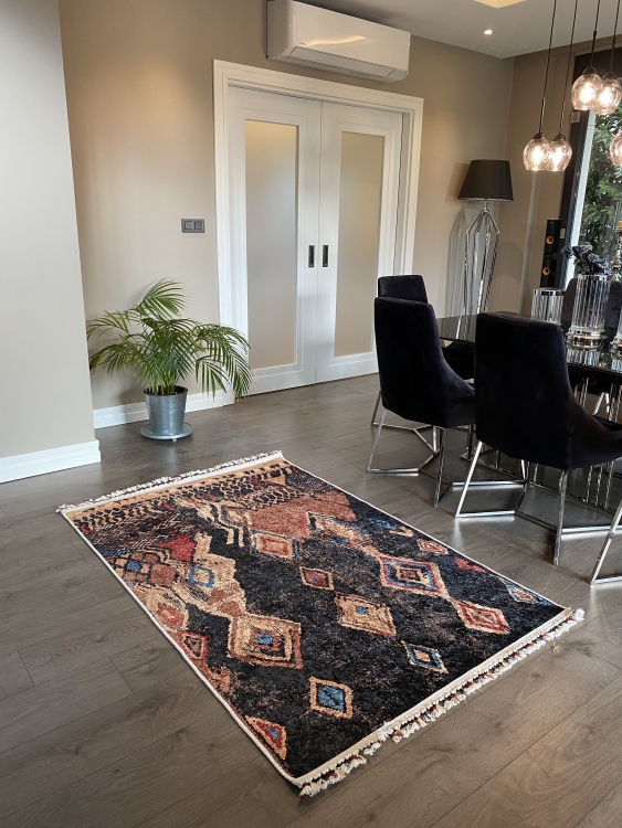 This vibrant digital printed rug features a bold pattern with pops of color, finished off with colorful fringes or braided fringes