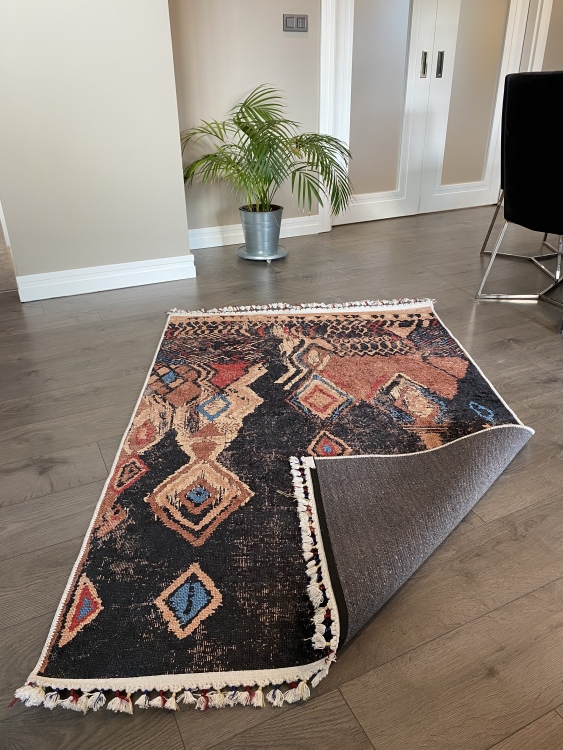 This vibrant digital printed rug features a bold pattern with pops of color, finished off with colorful fringes or braided fringes
