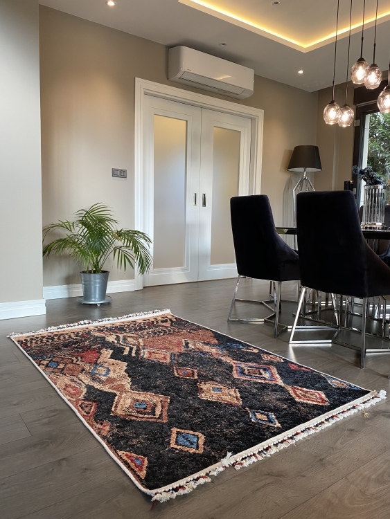 This vibrant digital printed rug features a bold pattern with pops of color, finished off with colorful fringes or braided fringes