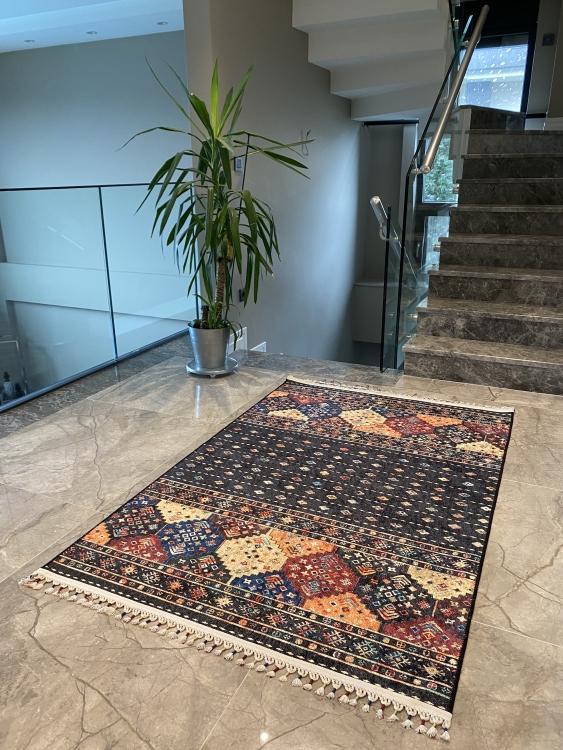This vibrant digital printed rug features a bold pattern with pops of color, finished off with colorful fringes or braided fringes