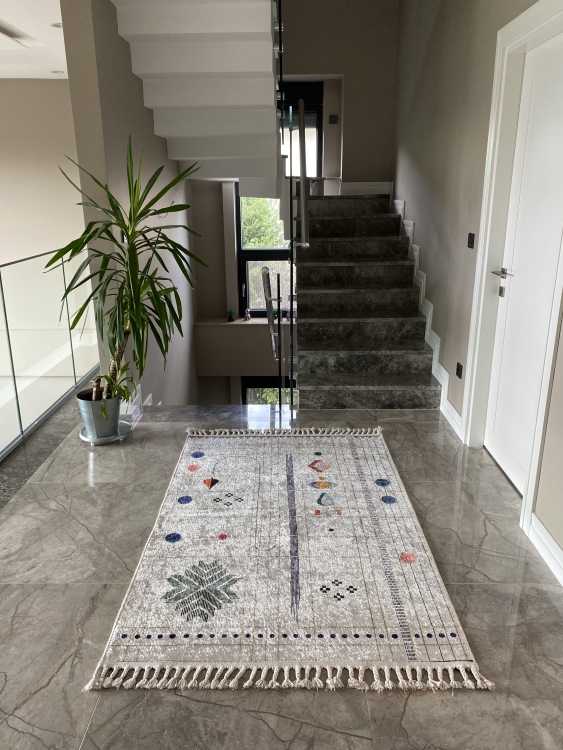 This vibrant digital printed rug features a bold pattern with pops of color, finished off with colorful fringes or braided fringes