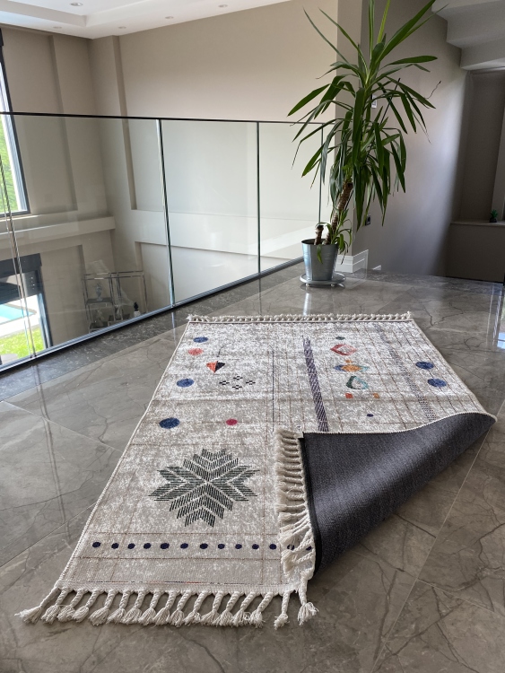 This vibrant digital printed rug features a bold pattern with pops of color, finished off with colorful fringes or braided fringes