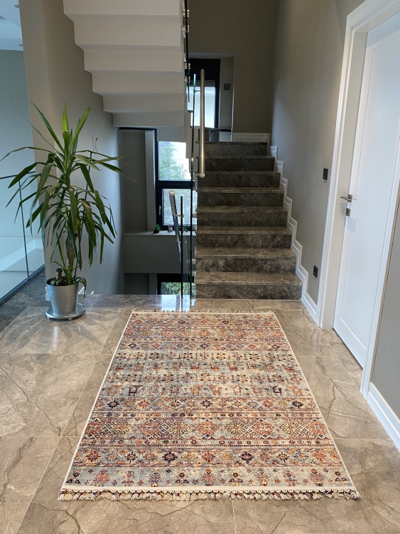 This vibrant digital printed rug features a bold pattern with pops of color, finished off with colorful fringes or braided fringes