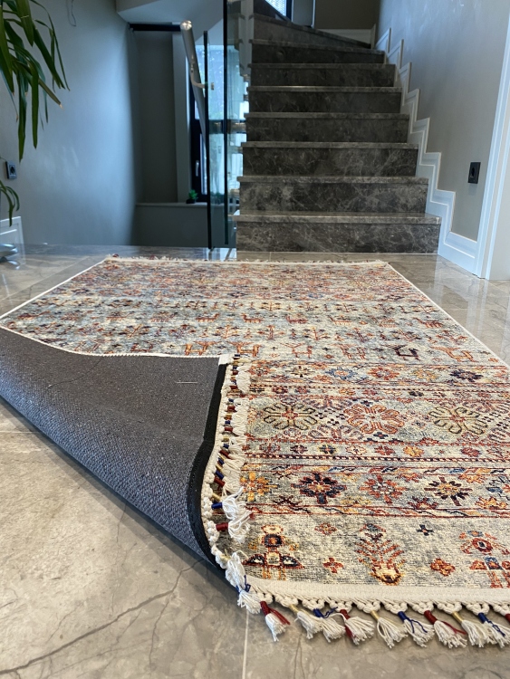 This vibrant digital printed rug features a bold pattern with pops of color, finished off with colorful fringes or braided fringes