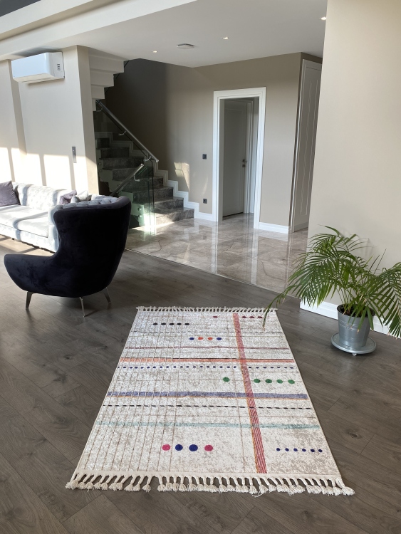 This vibrant digital printed rug features a bold pattern with pops of color, finished off with colorful fringes or braided fringes