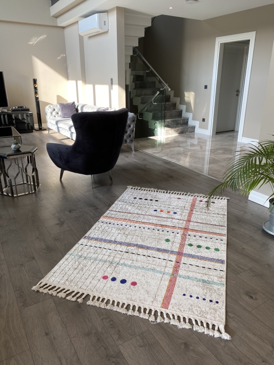 This vibrant digital printed rug features a bold pattern with pops of color, finished off with colorful fringes or braided fringes