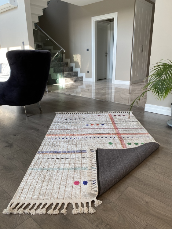 This vibrant digital printed rug features a bold pattern with pops of color, finished off with colorful fringes or braided fringes