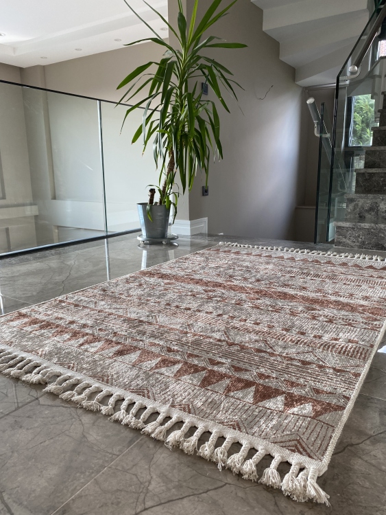 This vibrant digital printed rug features a bold pattern with pops of color, finished off with colorful fringes or braided fringes