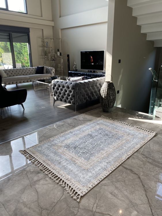 This vibrant digital printed rug features a bold pattern with pops of color, finished off with colorful fringes or braided fringes