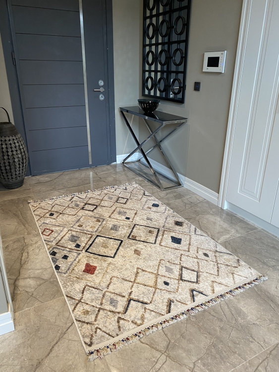 This vibrant digital printed rug features a bold pattern with pops of color, finished off with colorful fringes or braided fringes