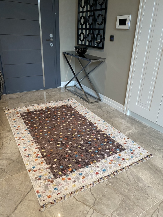 This vibrant digital printed rug features a bold pattern with pops of color, finished off with colorful fringes or braided fringes