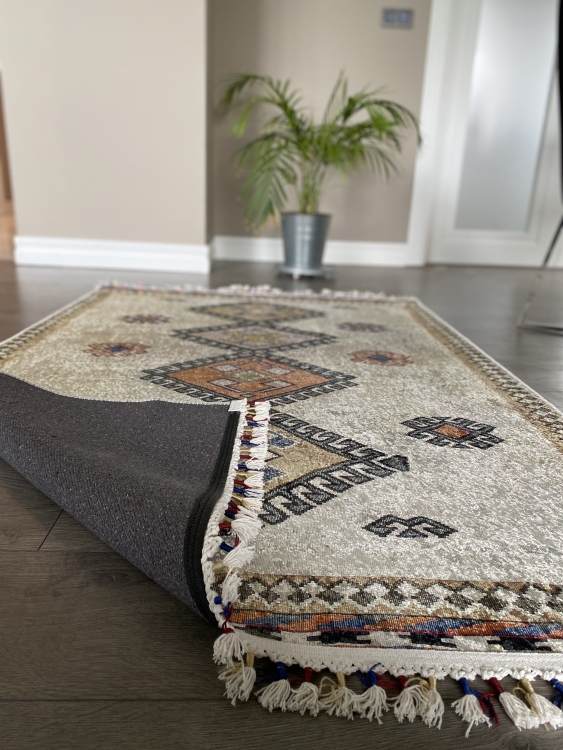 This vibrant digital printed rug features a bold pattern with pops of color, finished off with colorful fringes or braided fringes