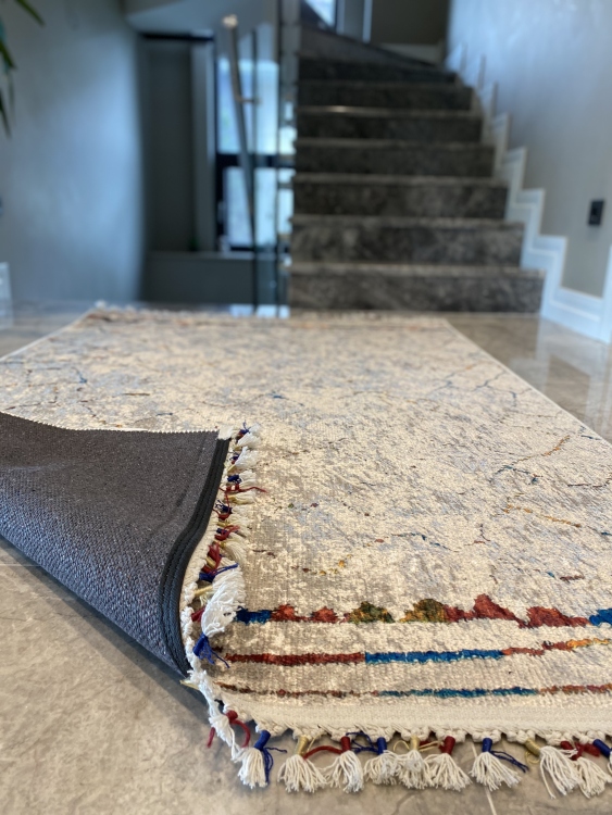 This vibrant digital printed rug features a bold pattern with pops of color, finished off with colorful fringes or braided fringes