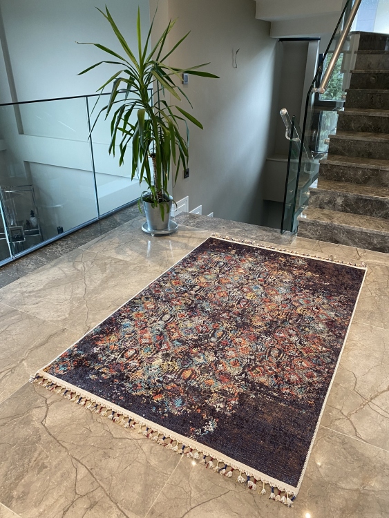 This vibrant digital printed rug features a bold pattern with pops of color, finished off with colorful fringes or braided fringes
