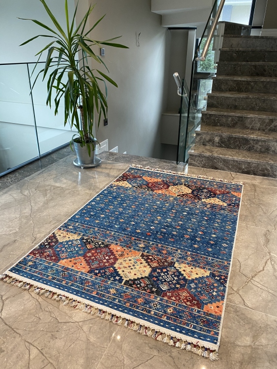 This vibrant digital printed rug features a bold pattern with pops of color, finished off with colorful fringes or braided fringes