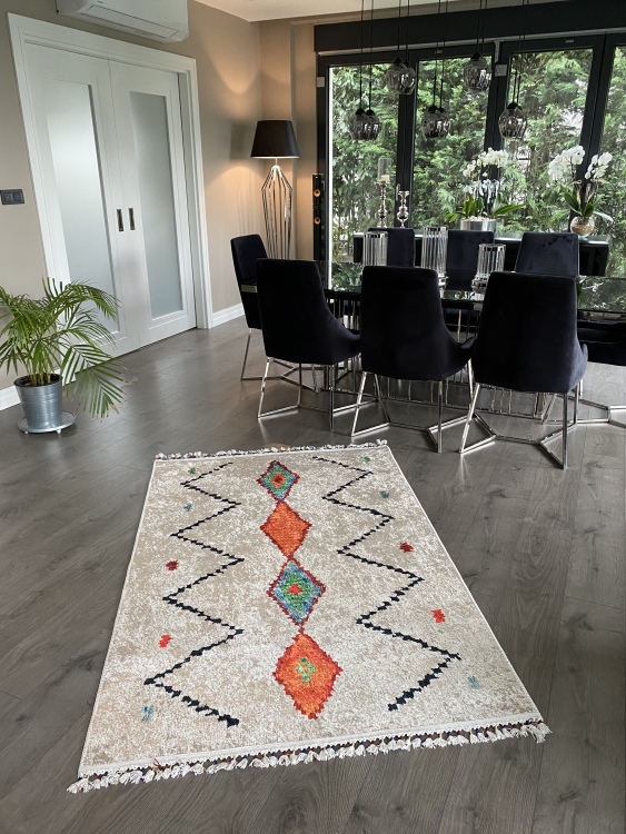This vibrant digital printed rug features a bold pattern with pops of color, finished off with colorful fringes or braided fringes
