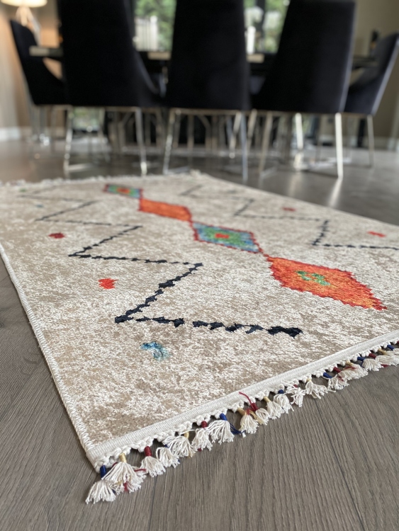 This vibrant digital printed rug features a bold pattern with pops of color, finished off with colorful fringes or braided fringes