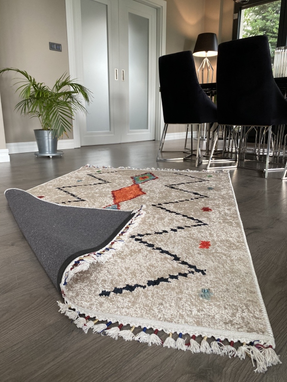 This vibrant digital printed rug features a bold pattern with pops of color, finished off with colorful fringes or braided fringes