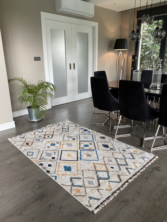 This vibrant digital printed rug features a bold pattern with pops of color, finished off with colorful fringes or braided fringes