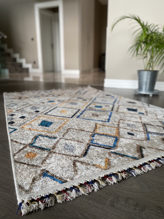 This vibrant digital printed rug features a bold pattern with pops of color, finished off with colorful fringes or braided fringes