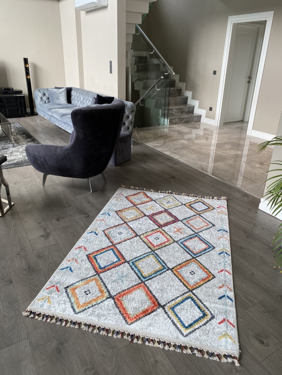 This vibrant digital printed rug features a bold pattern with pops of color, finished off with colorful fringes or braided fringes