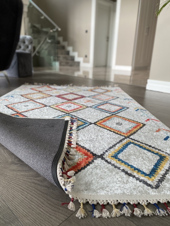 This vibrant digital printed rug features a bold pattern with pops of color, finished off with colorful fringes or braided fringes