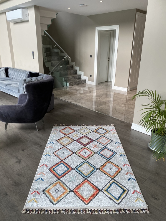 This vibrant digital printed rug features a bold pattern with pops of color, finished off with colorful fringes or braided fringes
