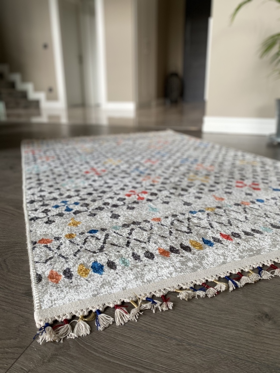 This vibrant digital printed rug features a bold pattern with pops of color, finished off with colorful fringes or braided fringes