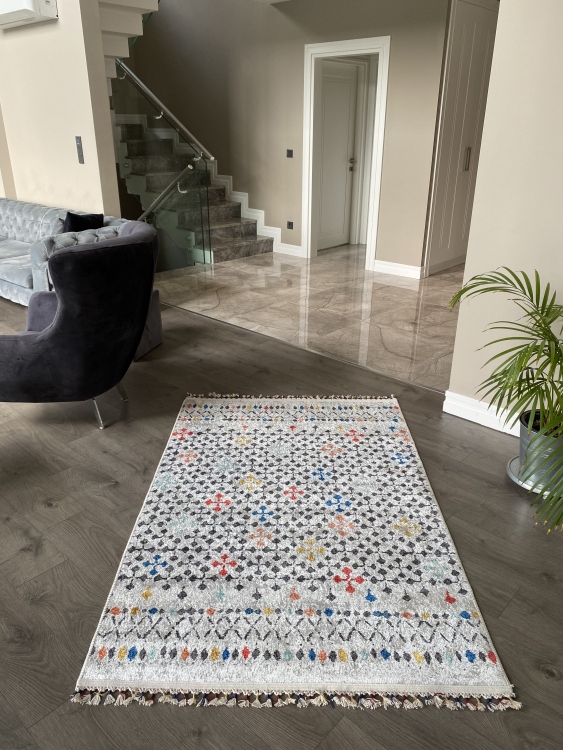 This vibrant digital printed rug features a bold pattern with pops of color, finished off with colorful fringes or braided fringes