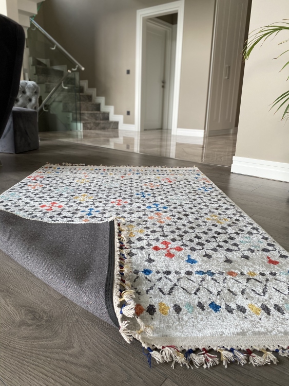 This vibrant digital printed rug features a bold pattern with pops of color, finished off with colorful fringes or braided fringes