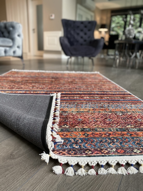 This vibrant digital printed rug features a bold pattern with pops of color, finished off with colorful fringes or braided fringes
