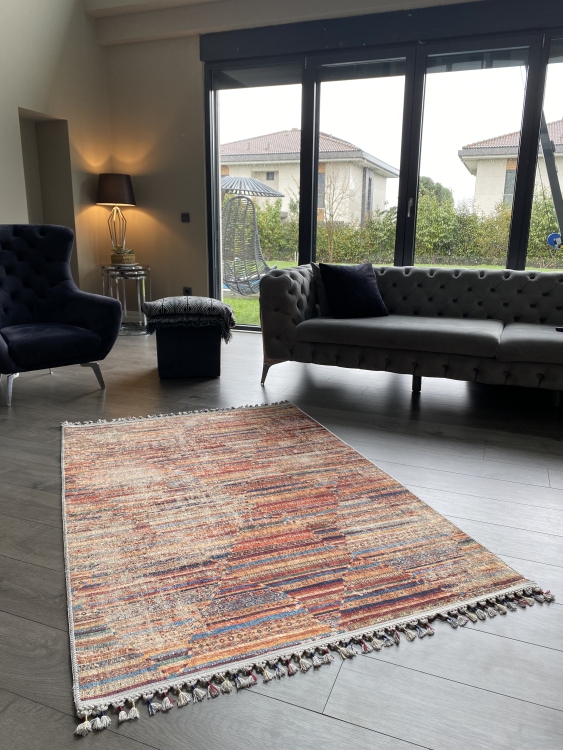 This vibrant digital printed rug features a bold pattern with pops of color, finished off with colorful fringes or braided fringes