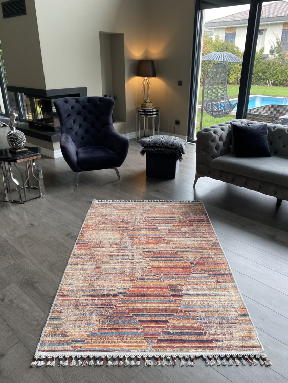 This vibrant digital printed rug features a bold pattern with pops of color, finished off with colorful fringes or braided fringes
