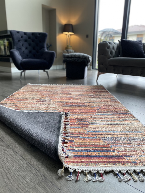 This vibrant digital printed rug features a bold pattern with pops of color, finished off with colorful fringes or braided fringes