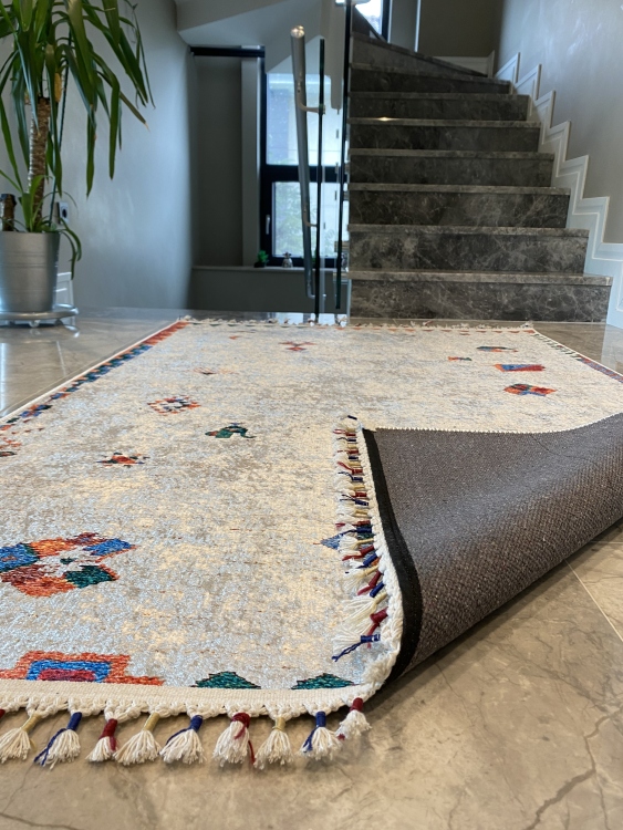 This vibrant digital printed rug features a bold pattern with pops of color, finished off with colorful fringes or braided fringes