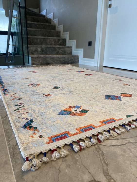 This vibrant digital printed rug features a bold pattern with pops of color, finished off with colorful fringes or braided fringes