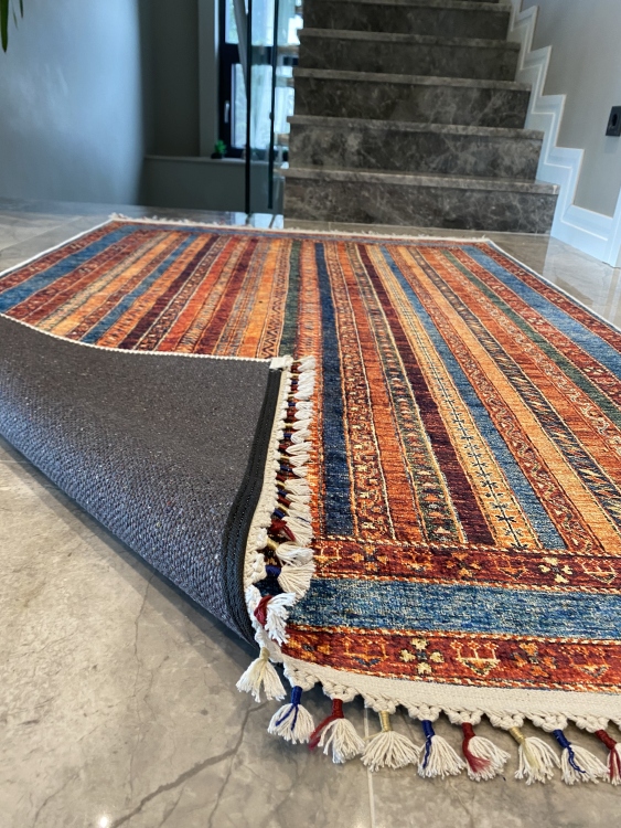 This vibrant digital printed rug features a bold pattern with pops of color, finished off with colorful fringes or braided fringes