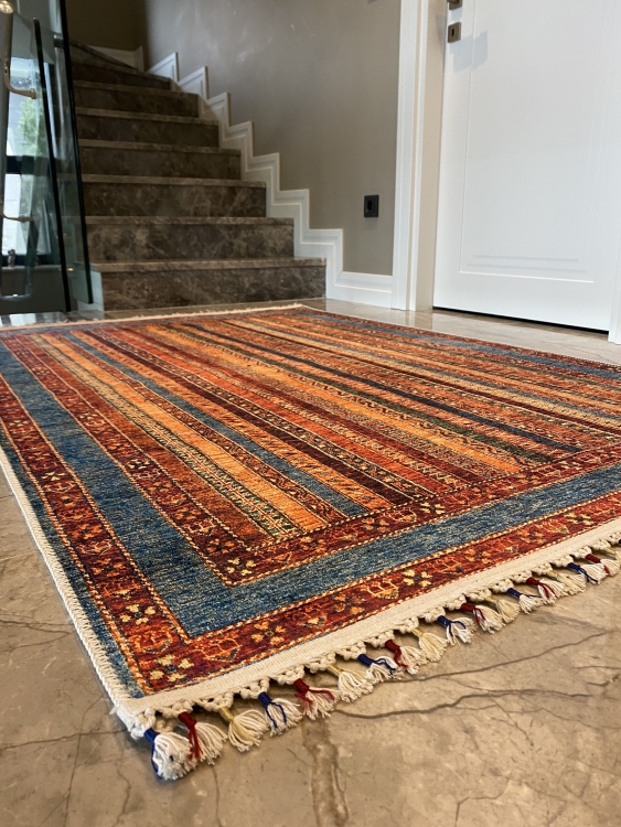 This vibrant digital printed rug features a bold pattern with pops of color, finished off with colorful fringes or braided fringes