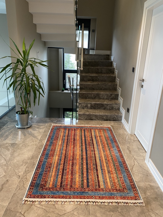 This vibrant digital printed rug features a bold pattern with pops of color, finished off with colorful fringes or braided fringes