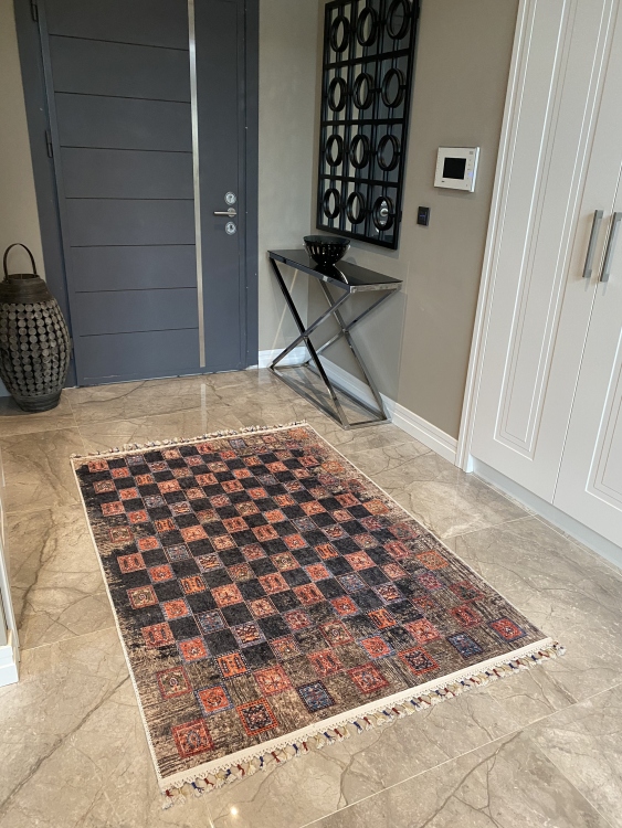 This vibrant digital printed rug features a bold pattern with pops of color, finished off with colorful fringes or braided fringes