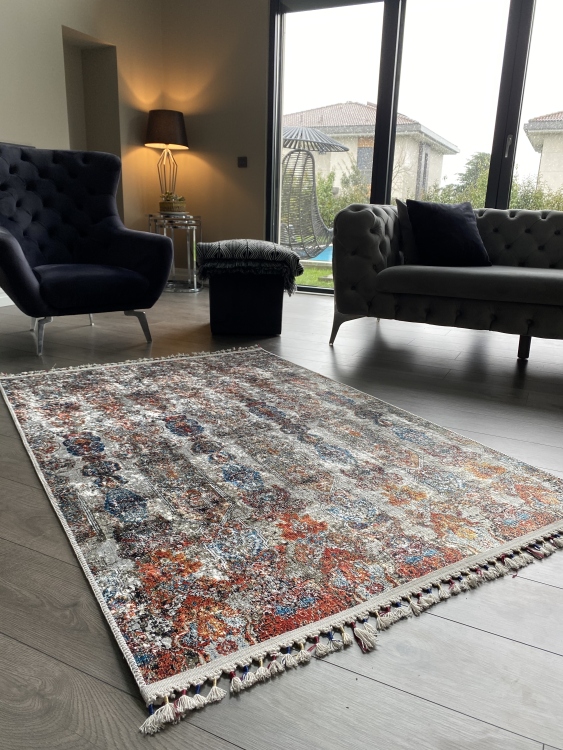 This vibrant digital printed rug features a bold pattern with pops of color, finished off with colorful fringes or braided fringes