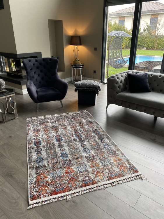 This vibrant digital printed rug features a bold pattern with pops of color, finished off with colorful fringes or braided fringes