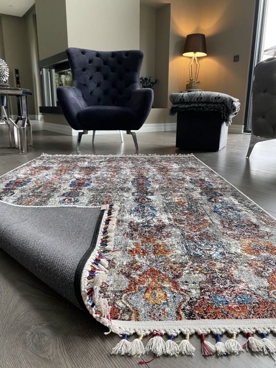 This vibrant digital printed rug features a bold pattern with pops of color, finished off with colorful fringes or braided fringes